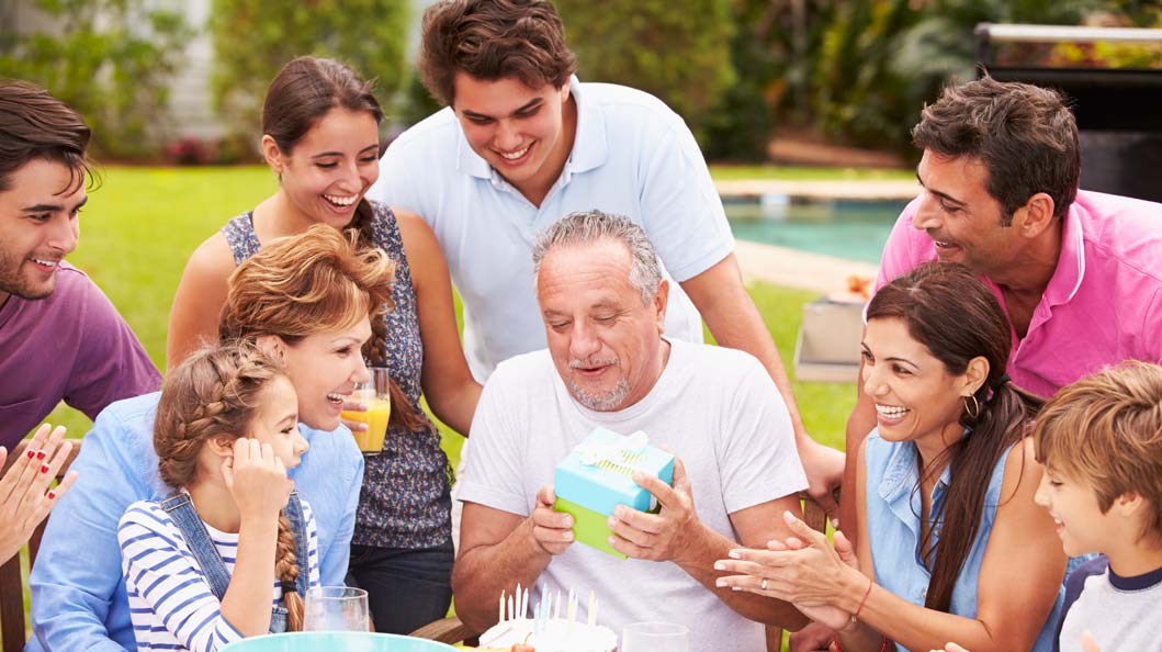 Children appreciating their dad by gifting and making time for him Children appreciating their dad by gifting and making time for him