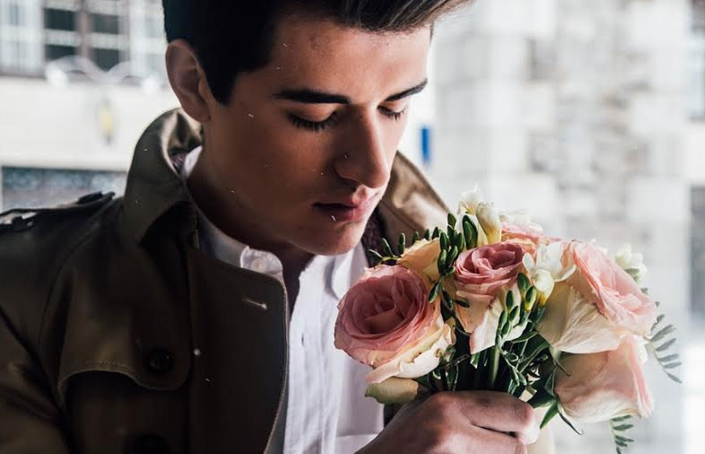 A handsome man with a gift of beautiful flowers A handsome man with a gift of beautiful flowers