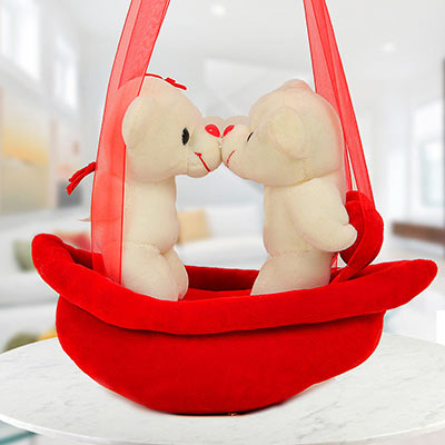 A Cuddly Cute Present Standing on a Red Swing A Cuddly Cute Present Standing on a Red Swing