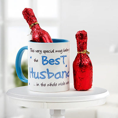 A Combo Of Chocolate And Ceramic Mug On Which Best Husband Is Printed