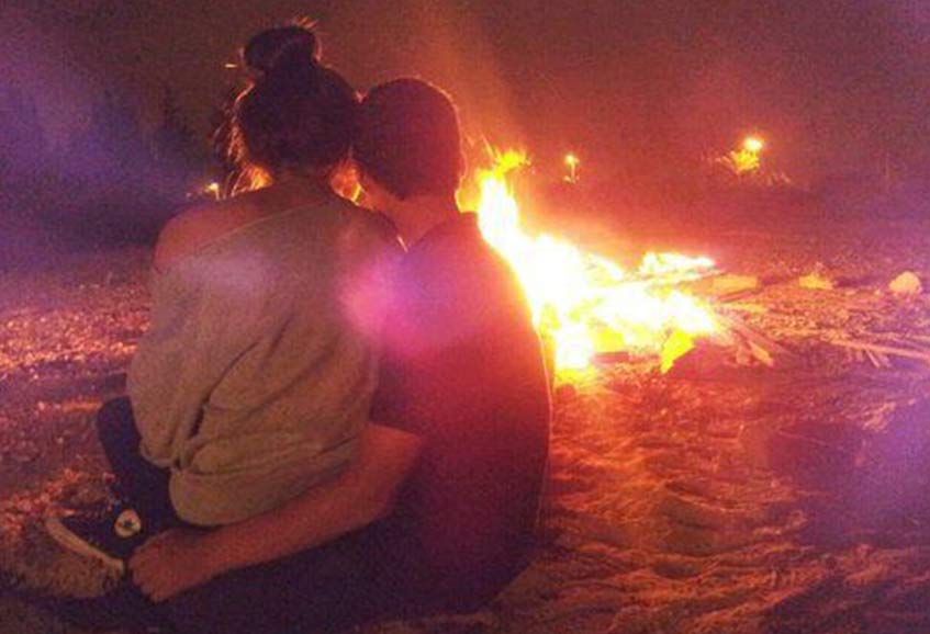 A Romantic Couple Enjoying Bonfire on Valentine Day A Romantic Couple Enjoying Bonfire on Valentine Day